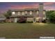 Large, private backyard with a patio, outdoor furniture, mature trees, and well-kept lawn at 243 Kensington Trce, Stockbridge, GA 30281