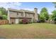 Expansive backyard with lush lawn, mature landscaping, and a patio perfect for outdoor entertaining at 243 Kensington Trce, Stockbridge, GA 30281
