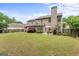 Spacious backyard featuring a well-maintained lawn, a patio with seating, and lush greenery at 243 Kensington Trce, Stockbridge, GA 30281