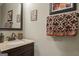 Bathroom featuring granite countertop vanity and decorative towels at 243 Kensington Trce, Stockbridge, GA 30281