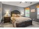 Comfortable bedroom with a tray ceiling, two side tables, and yellow accents at 243 Kensington Trce, Stockbridge, GA 30281