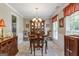 Formal dining room with chandelier lighting and large window at 243 Kensington Trce, Stockbridge, GA 30281