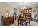 Formal dining room with a decorative hutch and dining table at 243 Kensington Trce, Stockbridge, GA 30281