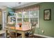 Bright dining area featuring natural light, wooden table, and classic decor at 243 Kensington Trce, Stockbridge, GA 30281