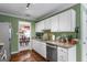 Kitchen with white cabinetry, stainless appliances, and granite countertops at 243 Kensington Trce, Stockbridge, GA 30281