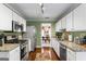 Well-equipped kitchen with stainless steel appliances, granite countertops, and wooden floors at 243 Kensington Trce, Stockbridge, GA 30281