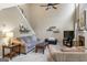 Comfortable living room with a sofa, armchair, fireplace and high ceilings at 243 Kensington Trce, Stockbridge, GA 30281