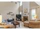Spacious living room with fireplace, TV, and large windows at 243 Kensington Trce, Stockbridge, GA 30281