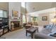 Open-concept living room with fireplace, connecting to dining area at 243 Kensington Trce, Stockbridge, GA 30281