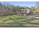 Exterior of home featuring a spacious deck with stairs and overlooking a large backyard at 1234 Coweta Heard Rd, Hogansville, GA 30230