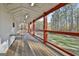 Spacious back porch with wooden floors, metal railings, red support beams, and view of the backyard at 1234 Coweta Heard Rd, Hogansville, GA 30230