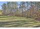 Beautiful expansive backyard with mature trees offering serene views and ample space at 1234 Coweta Heard Rd, Hogansville, GA 30230