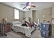 Bedroom with a ceiling fan, window, and some clutter; in need of decluttering and organizing at 1234 Coweta Heard Rd, Hogansville, GA 30230