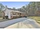 Paved driveway leading to a charming home, complemented by a lush lawn and mature trees at 1234 Coweta Heard Rd, Hogansville, GA 30230