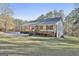Well-maintained home on a green lawn, boasting a charming porch and a serene, wooded backdrop at 1234 Coweta Heard Rd, Hogansville, GA 30230