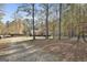 A distant view of a charming home nestled among tall trees, highlighting the property's privacy at 1234 Coweta Heard Rd, Hogansville, GA 30230