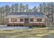 Charming ranch home featuring a welcoming porch, crisp white siding, and a well-manicured lawn at 1234 Coweta Heard Rd, Hogansville, GA 30230