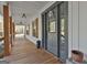 A view of the front porch featuring a dark front door, wood floors, and natural light at 1234 Coweta Heard Rd, Hogansville, GA 30230