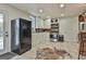 Well-lit kitchen boasting white cabinetry, stainless steel appliances, and an inviting design at 1234 Coweta Heard Rd, Hogansville, GA 30230