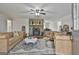 Inviting living room featuring a stone fireplace and comfortable leather furniture on hardwood floors at 1234 Coweta Heard Rd, Hogansville, GA 30230
