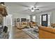 Spacious living area showcasing hardwood floors and a stone fireplace with comfortable leather furniture at 1234 Coweta Heard Rd, Hogansville, GA 30230