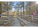 Scenic property view featuring a long gravel driveway leading to a beautiful house surrounded by trees at 1234 Coweta Heard Rd, Hogansville, GA 30230