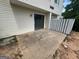 Back patio with sliding glass doors and a white fence at 1466 Pine Log Ne Rd # A, Conyers, GA 30012