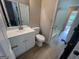 Bright bathroom featuring a white vanity, toilet, mirror and tub shower at 1466 Pine Log Ne Rd # A, Conyers, GA 30012