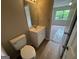 Bathroom featuring a white vanity, toilet, and view of the bedroom at 1466 Pine Log Ne Rd # A, Conyers, GA 30012