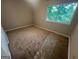 Bedroom with a large window overlooking the yard, and neutral carpeting at 1466 Pine Log Ne Rd # A, Conyers, GA 30012