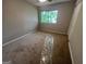 Bright bedroom with a large window overlooking the yard, and neutral carpeting at 1466 Pine Log Ne Rd # A, Conyers, GA 30012