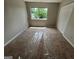 Cozy bedroom with neutral walls, carpet, and a window offering a view of the outdoors at 1466 Pine Log Ne Rd # A, Conyers, GA 30012