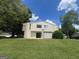 Exterior view of a two-story home with a well-manicured lawn and mature trees at 1466 Pine Log Ne Rd # A, Conyers, GA 30012