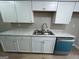 Updated kitchen with white cabinets, marble countertops, and a stainless-steel sink and dishwasher at 1466 Pine Log Ne Rd # A, Conyers, GA 30012