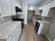 Modern kitchen with white cabinets, stone countertops, and stainless-steel appliances at 1466 Pine Log Ne Rd # A, Conyers, GA 30012