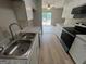 Updated kitchen featuring stainless steel sink, oven, white cabinets and light countertops at 1466 Pine Log Ne Rd # A, Conyers, GA 30012