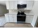 Contemporary kitchen featuring updated cabinetry, sleek countertops, and stainless-steel appliances at 1466 Pine Log Ne Rd # A, Conyers, GA 30012