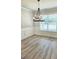 Bright dining room with hardwood floors, wainscoting, a chandelier and a large window overlooking the yard at 1715 Crumbley Rd # 2, Mcdonough, GA 30252