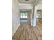 Bright foyer featuring hardwood floors, white trim, and an open floor plan to the dining and living spaces at 1715 Crumbley Rd # 2, Mcdonough, GA 30252