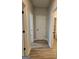 Hallway with hardwood floors, white trim, and access to multiple rooms in the home at 1715 Crumbley Rd # 2, Mcdonough, GA 30252