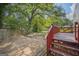 Red painted back deck overlooking the backyard and trees at 6369 Havenridge Dr, Riverdale, GA 30274