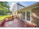 Back deck includes a red railing, brick wall, and sliding glass doors at 6369 Havenridge Dr, Riverdale, GA 30274
