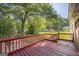 Spacious red deck with railings overlooks a lush, green backyard and neighborhood at 6369 Havenridge Dr, Riverdale, GA 30274