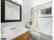 Bright bathroom featuring a shower-tub combo, classic vanity, and large mirror at 6369 Havenridge Dr, Riverdale, GA 30274