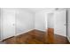 Empty room with hardwood floors, neutral paint, and view into another room at 6369 Havenridge Dr, Riverdale, GA 30274