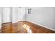 Bedroom with neutral paint and hardwood floors, features a window and closet at 6369 Havenridge Dr, Riverdale, GA 30274