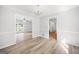 Bright dining room with new flooring, modern lighting fixture, and views into the living room and hall at 6369 Havenridge Dr, Riverdale, GA 30274