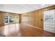 Spacious living room with hardwood floors, wood paneling, and lots of natural light at 6369 Havenridge Dr, Riverdale, GA 30274