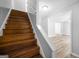 Staircase to open concept living room features stained wood treads and white risers at 6369 Havenridge Dr, Riverdale, GA 30274