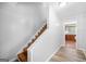 Interior staircase with new floor leading to updated kitchen area at 6369 Havenridge Dr, Riverdale, GA 30274
